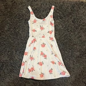 White mini dress wish pink floral accents.
